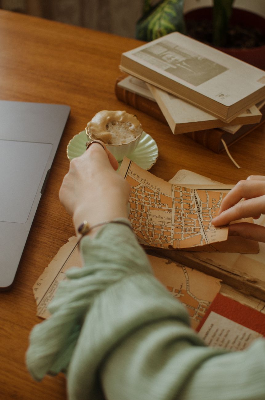 Travel writer examining maps in study